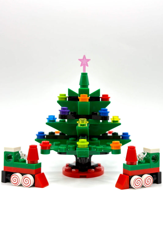 Close-up of LEGO Christmas train earrings showing festive tree details on white background