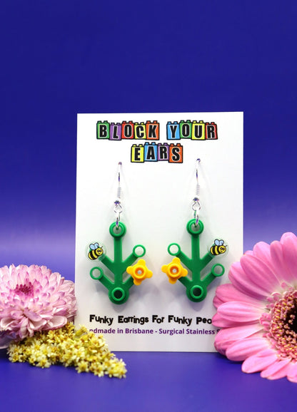 LEGO plant earrings with yellow flower and bee-Cute dangles on display card-Blue background with large flowers at side