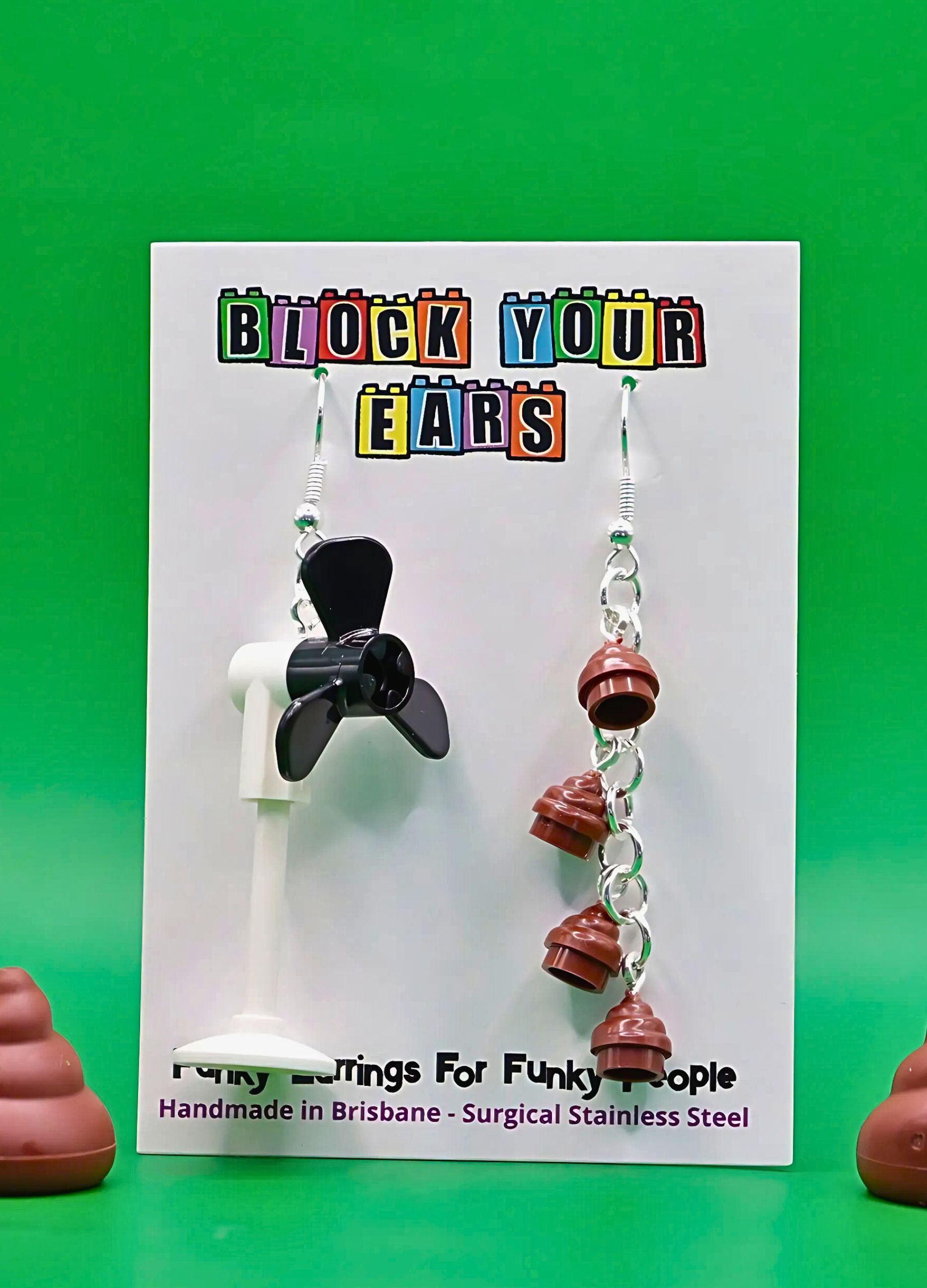 black-brown-fan-poo-lego-mismatched-earrings-green-background