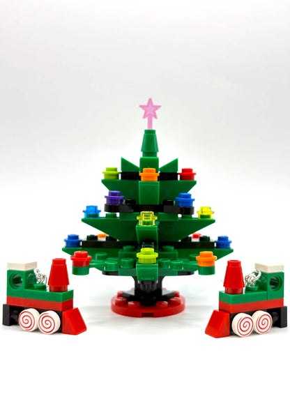 Close-up of LEGO Christmas train earrings showing festive tree details on white background