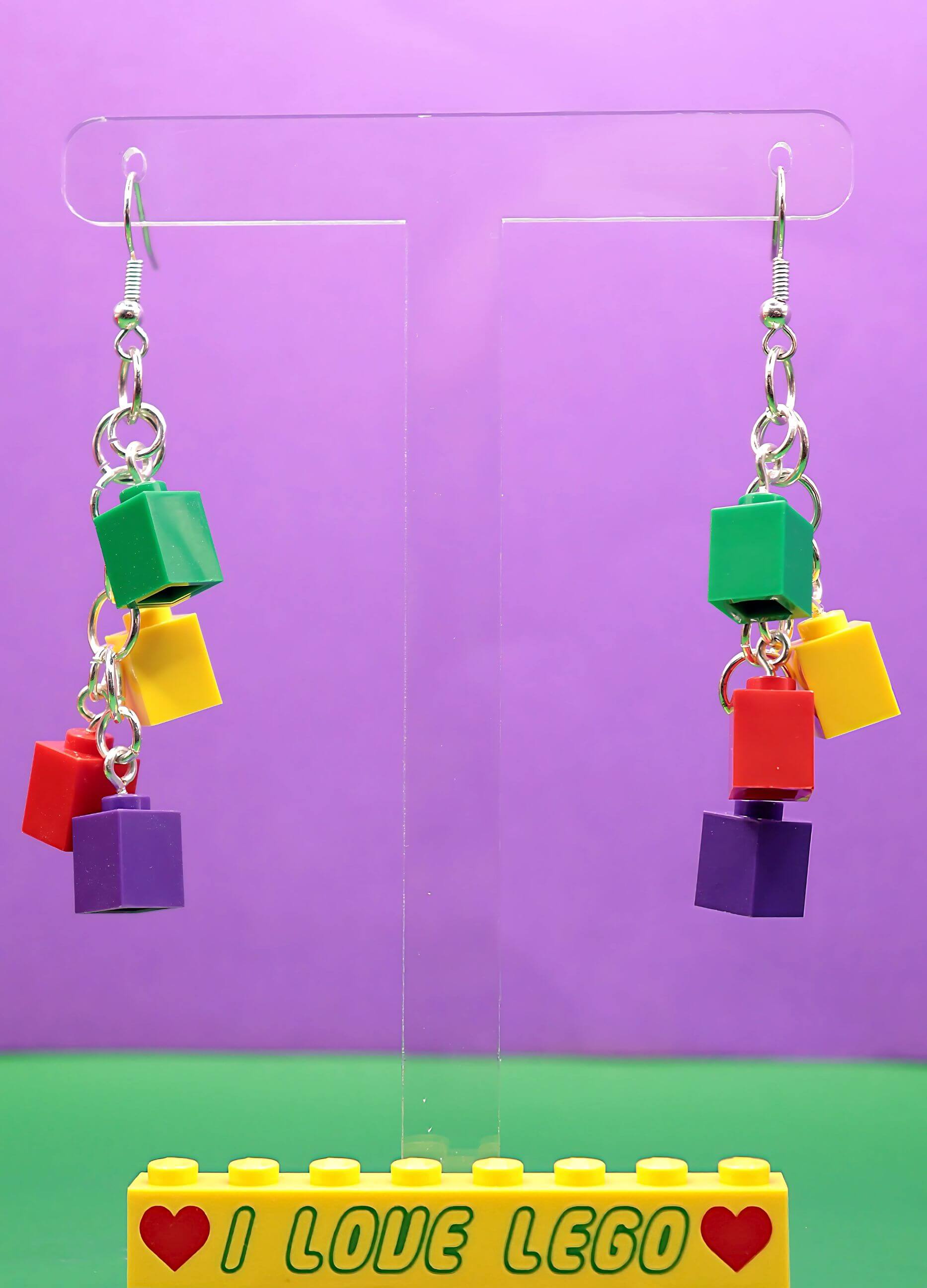green-yellow-red-purple-funky-lego-earrings-dangling-purple-background