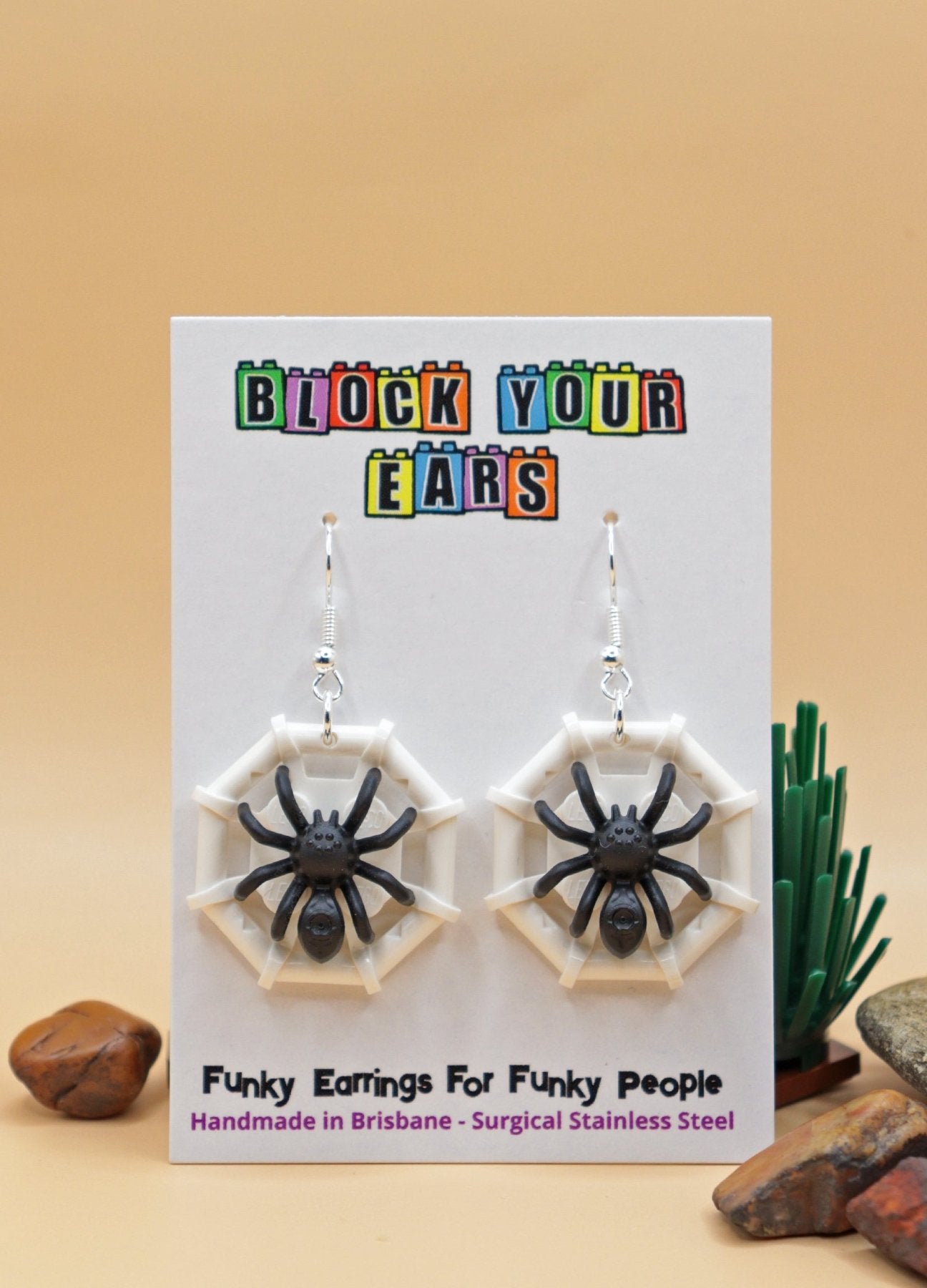 Black and white LEGO spider earrings-Spider on web – spooky Halloween novelty earrings on display card in desert scene