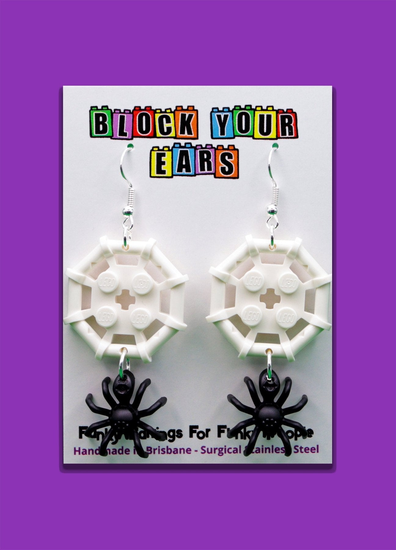 Black and white LEGO-style spider and web earrings – spooky Halloween novelty earrings on display card