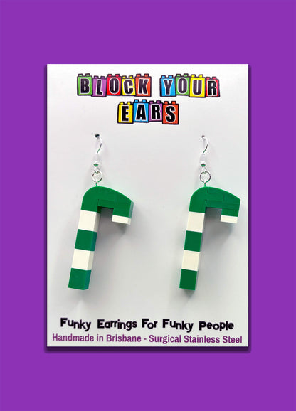 Handmade Merry Mintmas LEGO green white candy cane earrings on purple background