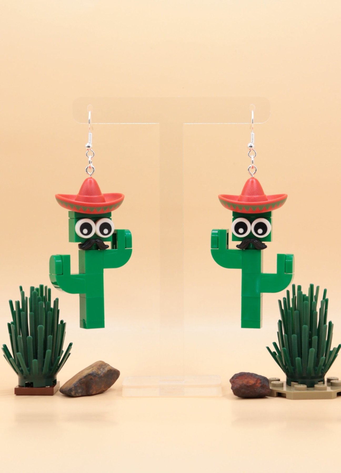 Moustachioed Amigos green LEGO cactus earrings, red sombreros, cartoon eyes, and black moustaches – novelty earrings-hanging