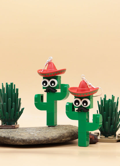 Moustachioed Amigos green LEGO cactus earrings, red sombreros, cartoon eyes, and black moustaches – novelty earrings-on rock