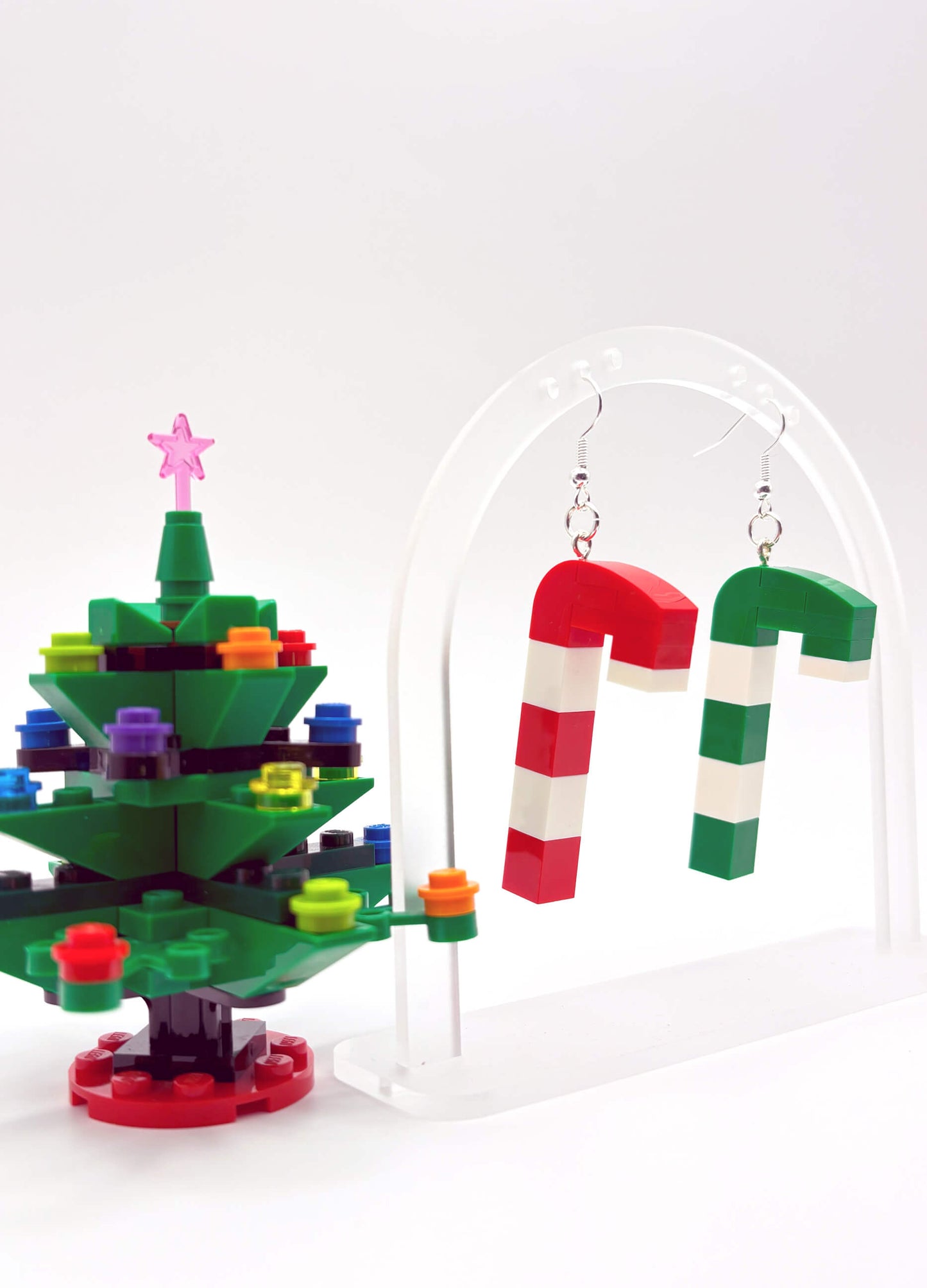 Mismatched LEGO candy cane earrings hanging freely, playful festive statement jewellery