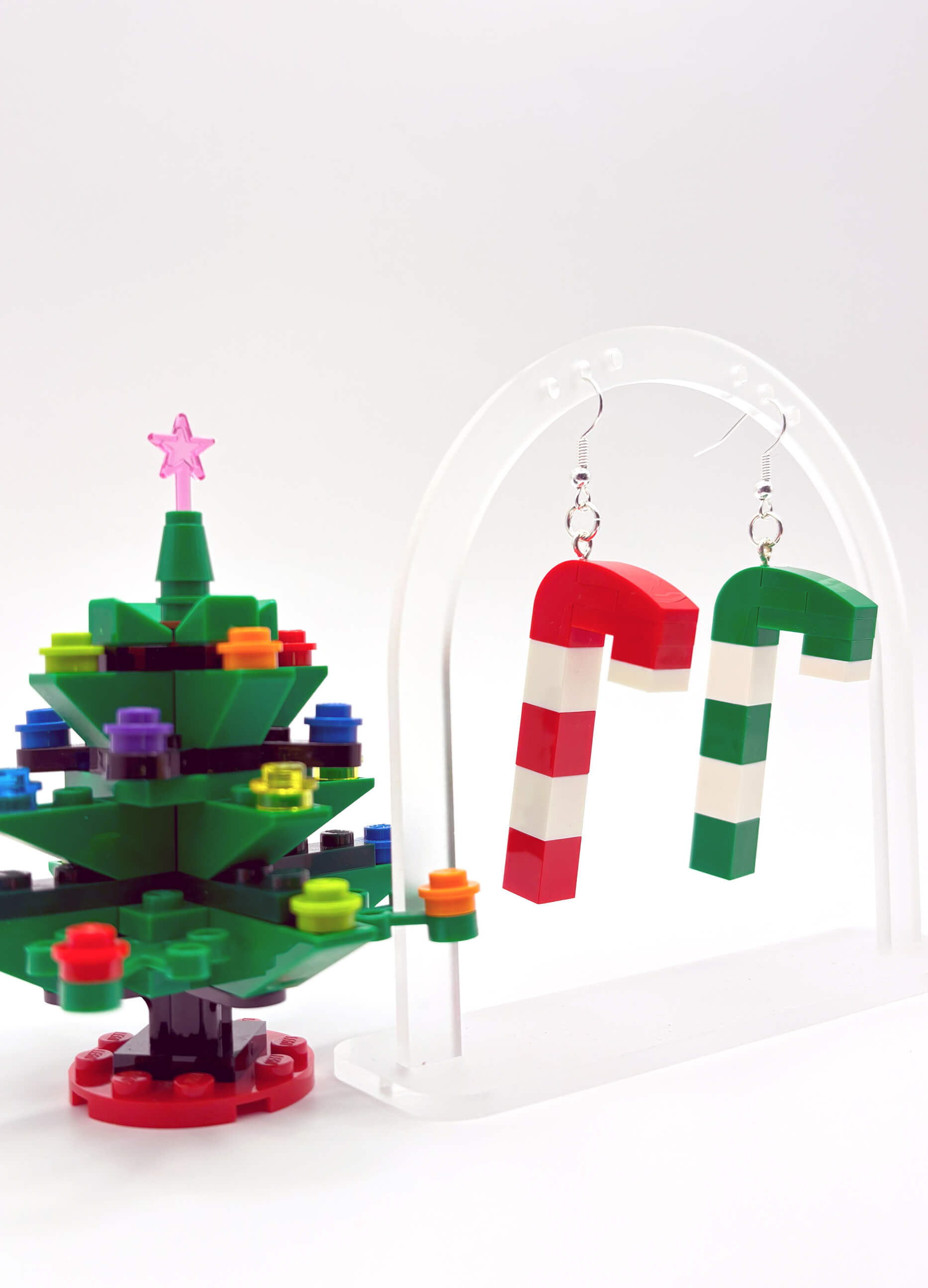 Mismatched LEGO candy cane earrings hanging freely, playful festive statement jewellery
