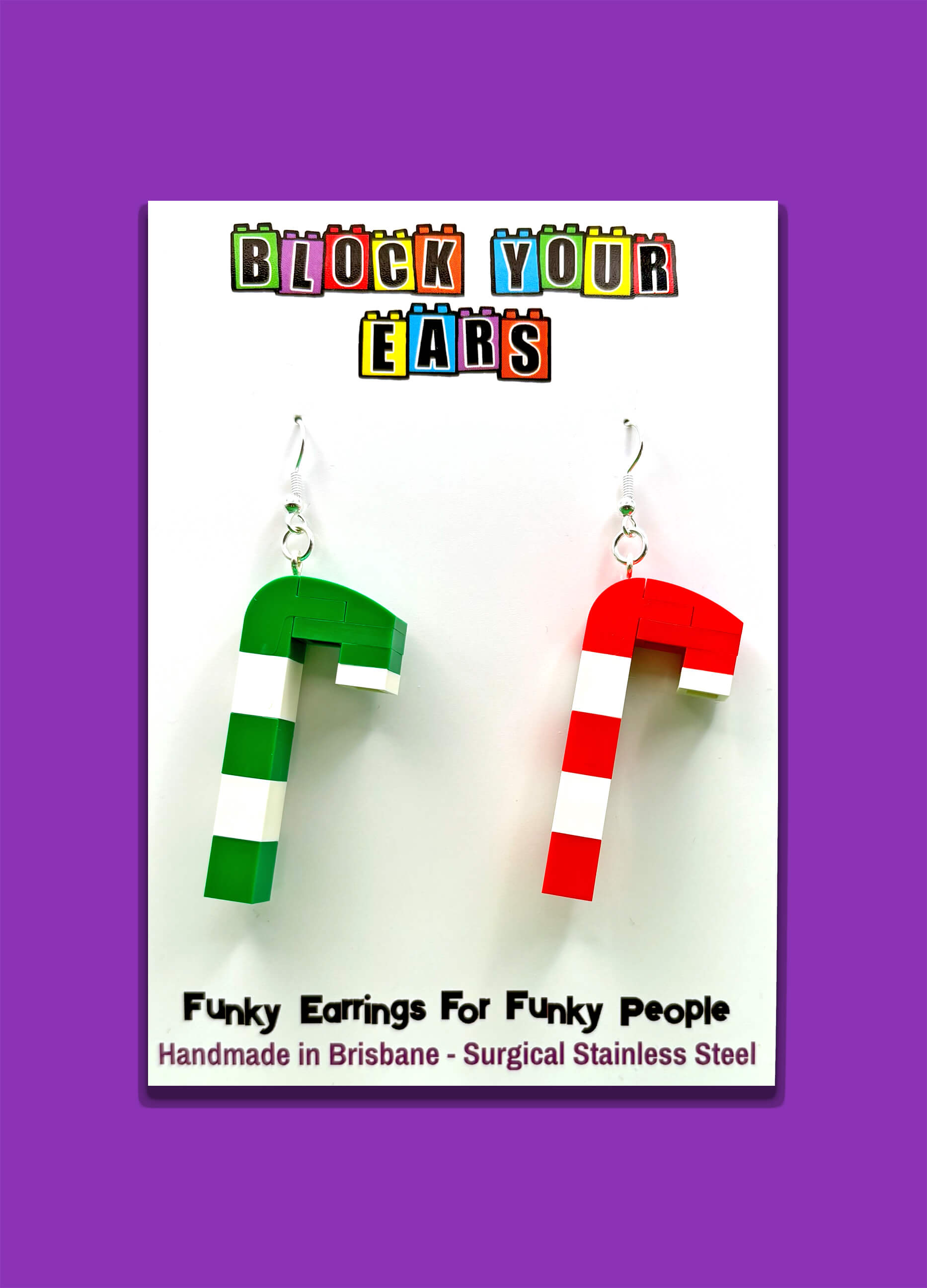Mismatched LEGO candy cane earrings, one red and white and one green and white, festive holiday jewellery