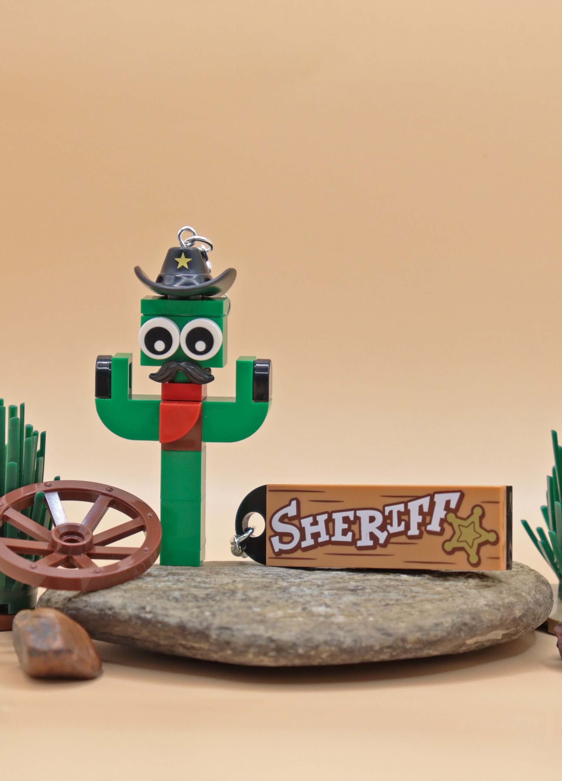 Funky LEGO cactus earring with moustache and sheriff hat - Green-Red on rock