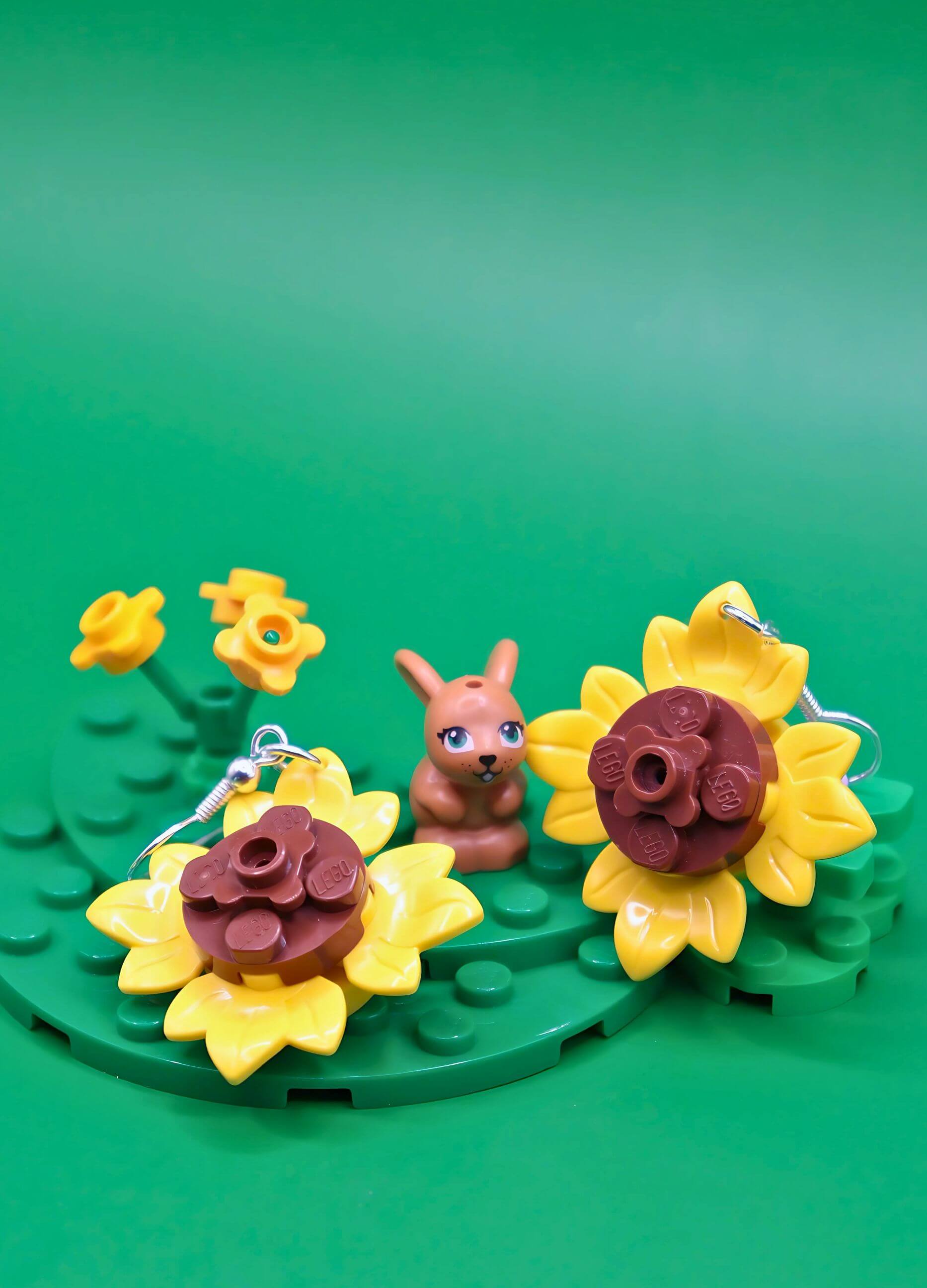 Close-up of sunflower LEGO earrings showing yellow petals and brown centre details
