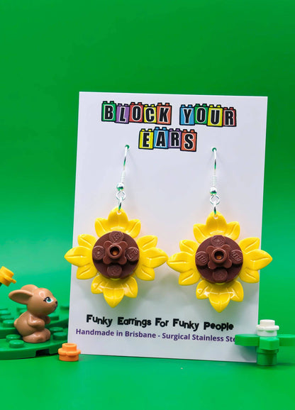 Bright sunflower LEGO dangle earrings shown on display card
