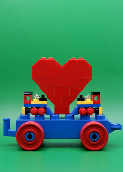 Miniature train earrings made from LEGO-Cute novelty earrings -Yellow/Blue/Red-heart-green background