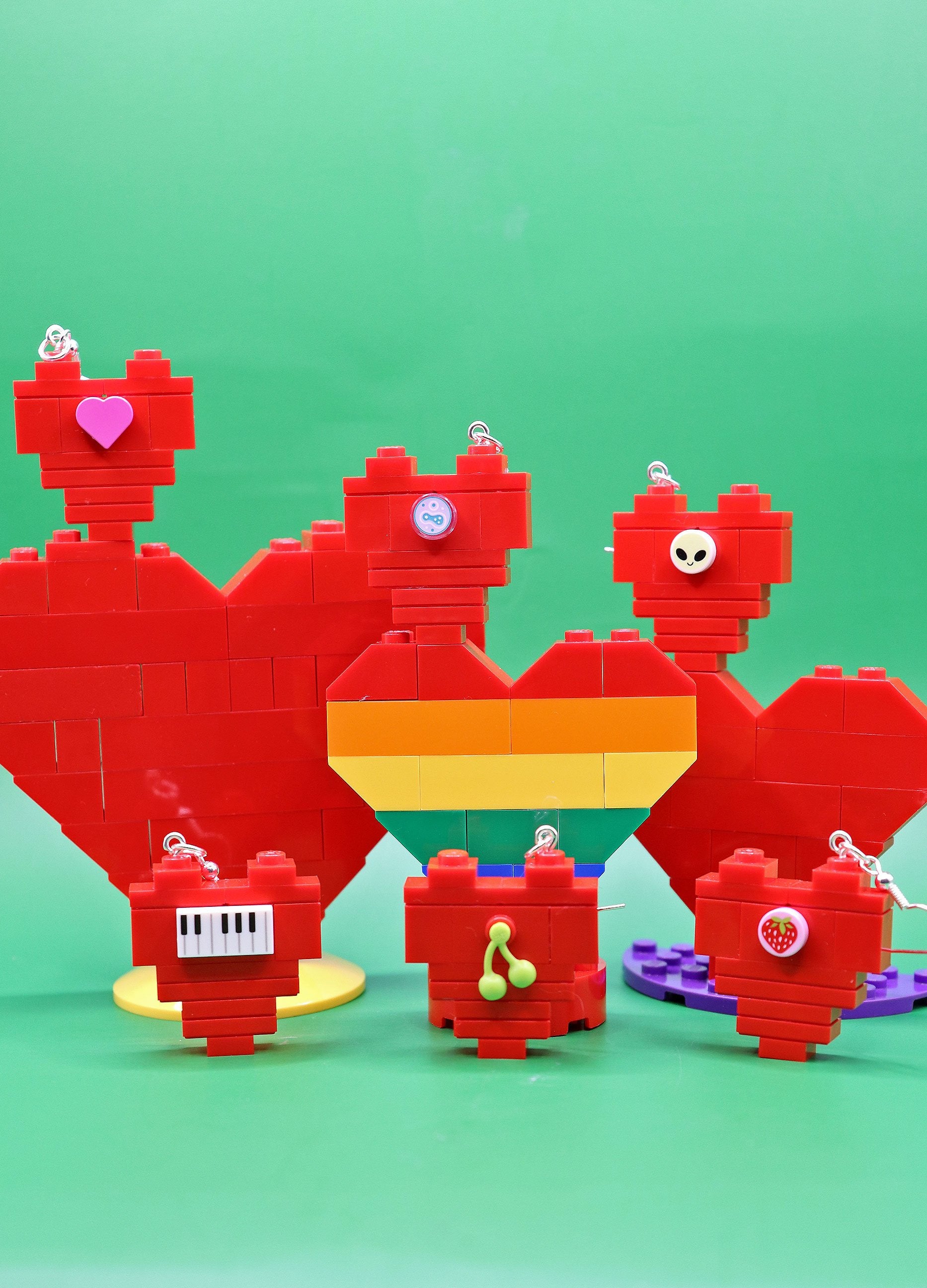 Red brick heart earrings - quirky - multiple on green backgroud