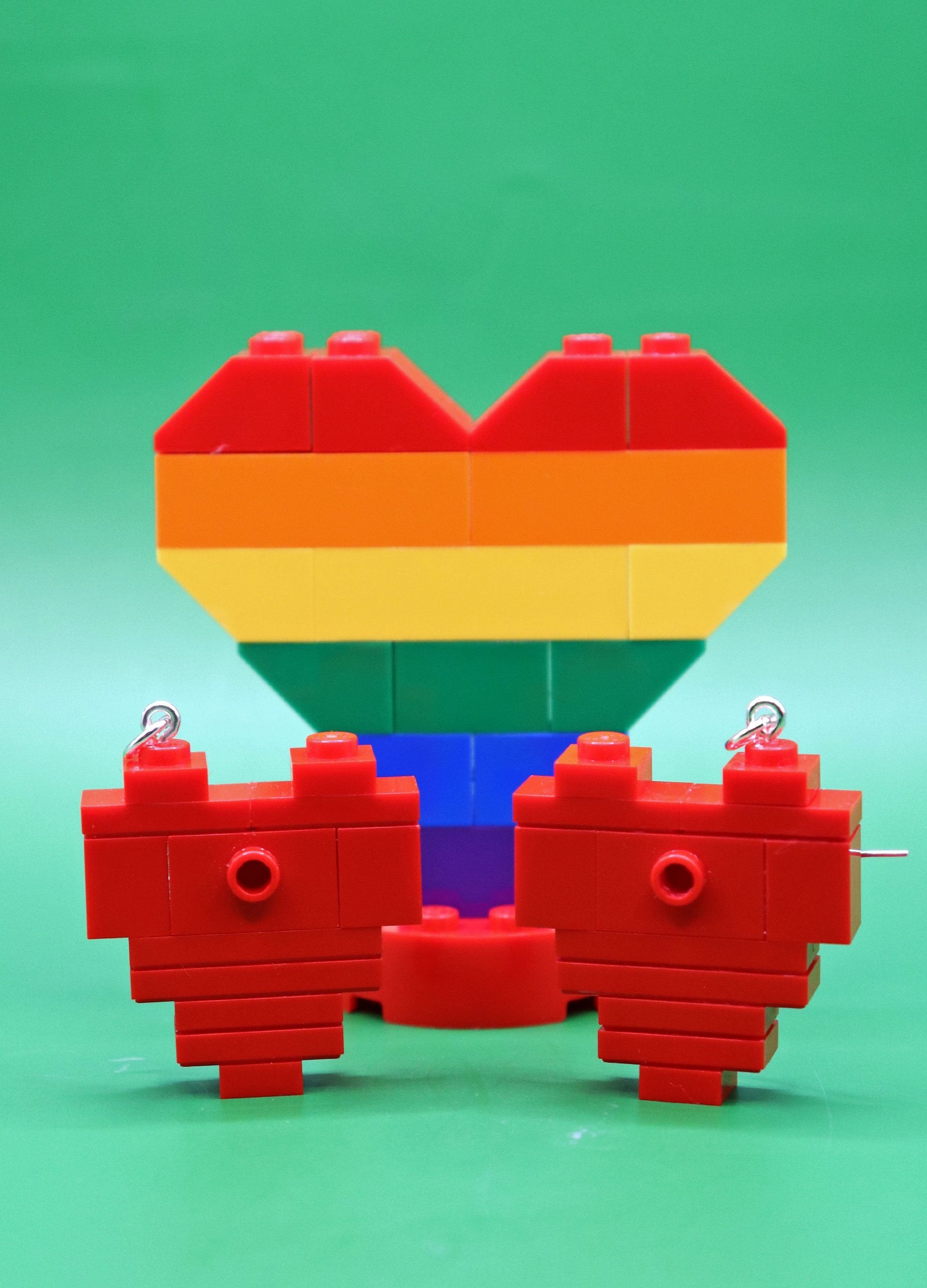 Red brick hearts - quirky LEGO earrings on green background with Large Rainbow heart