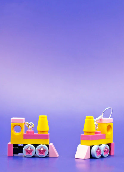 Close up and side view of yellow and pink handmade LEGO steam train dangle earrings
